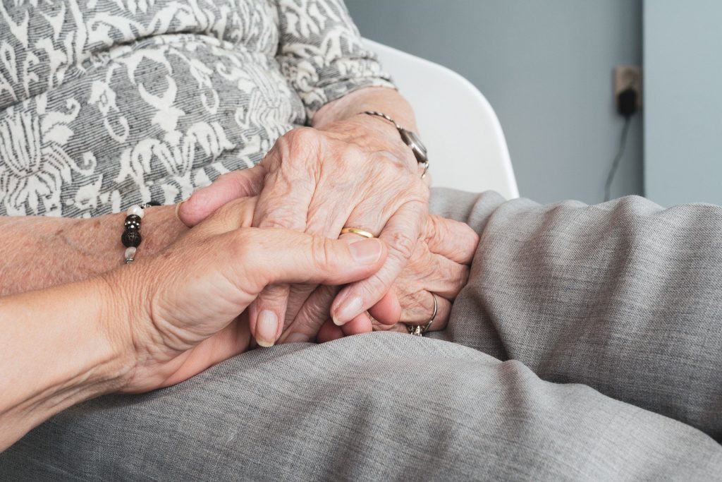 holding hands with patient